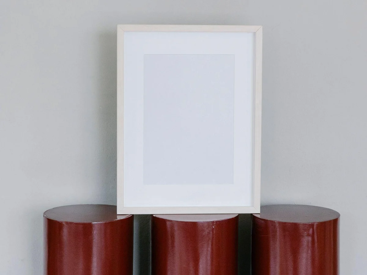 A pale print with a broad white border inside a simple frame.