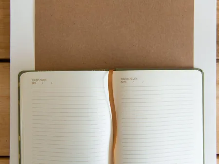 An open lined notebook with its centre binding visible.